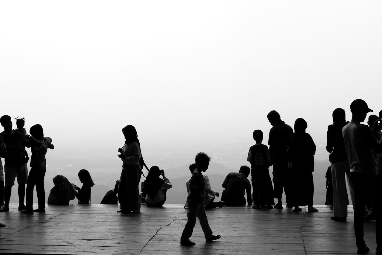 gallery-2 Monochrome silhouettes of people socializing on a scenic observation platform.
