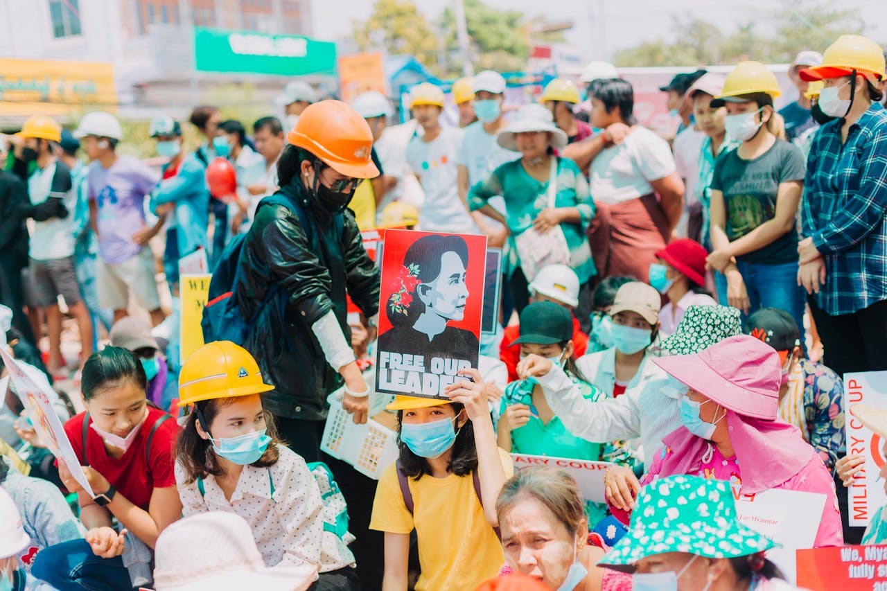 services-02 A large group of people in Yangon protests peacefully against the coup with signs and placards.